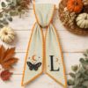Picture of Personalized Halloween Sash, Embroidered Butterfly Monogram Sash, Spooky Moon & Stars, Green Stripe Fall Sash, Halloween Gift for Her Decor
